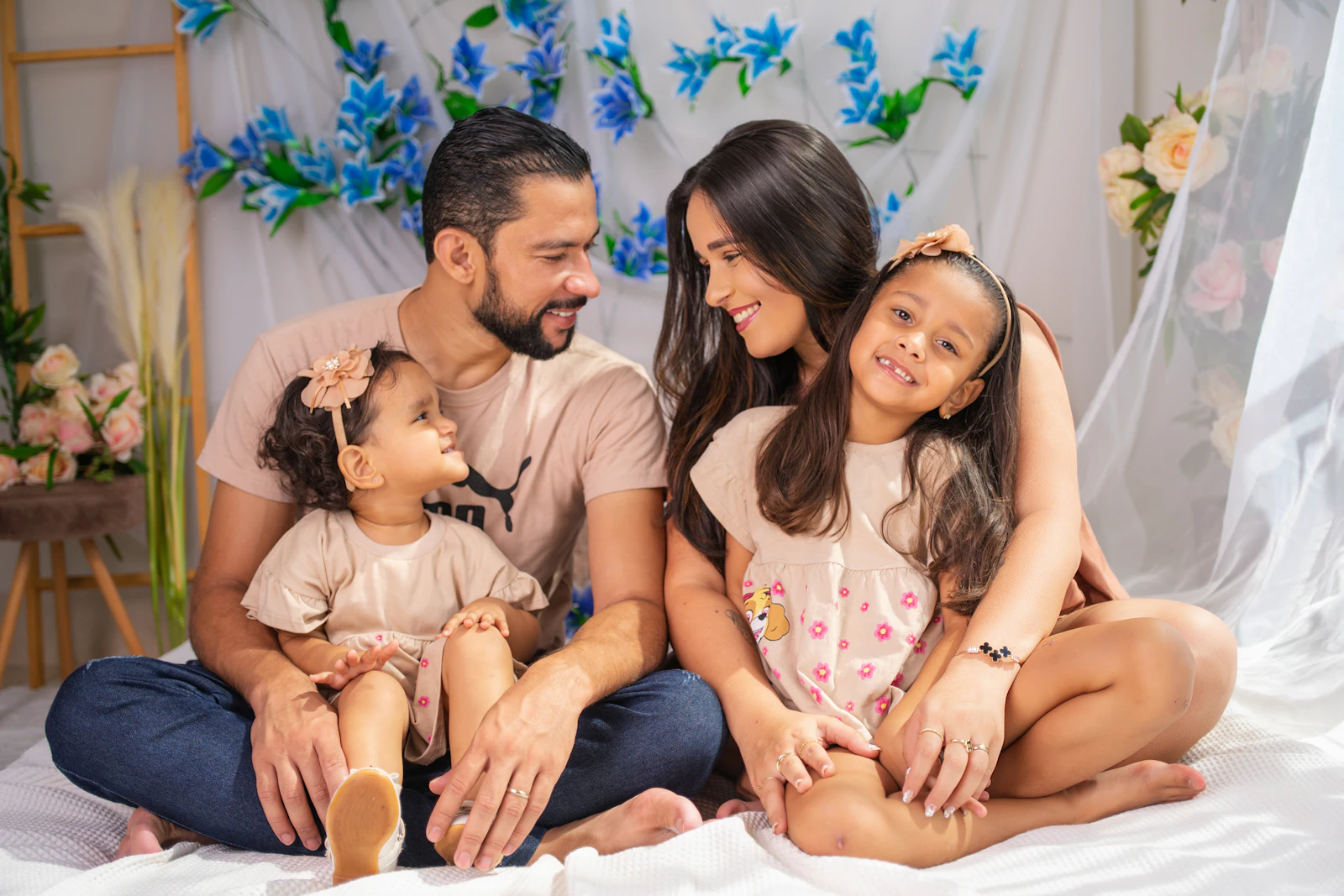 Young family of four sitting together at home