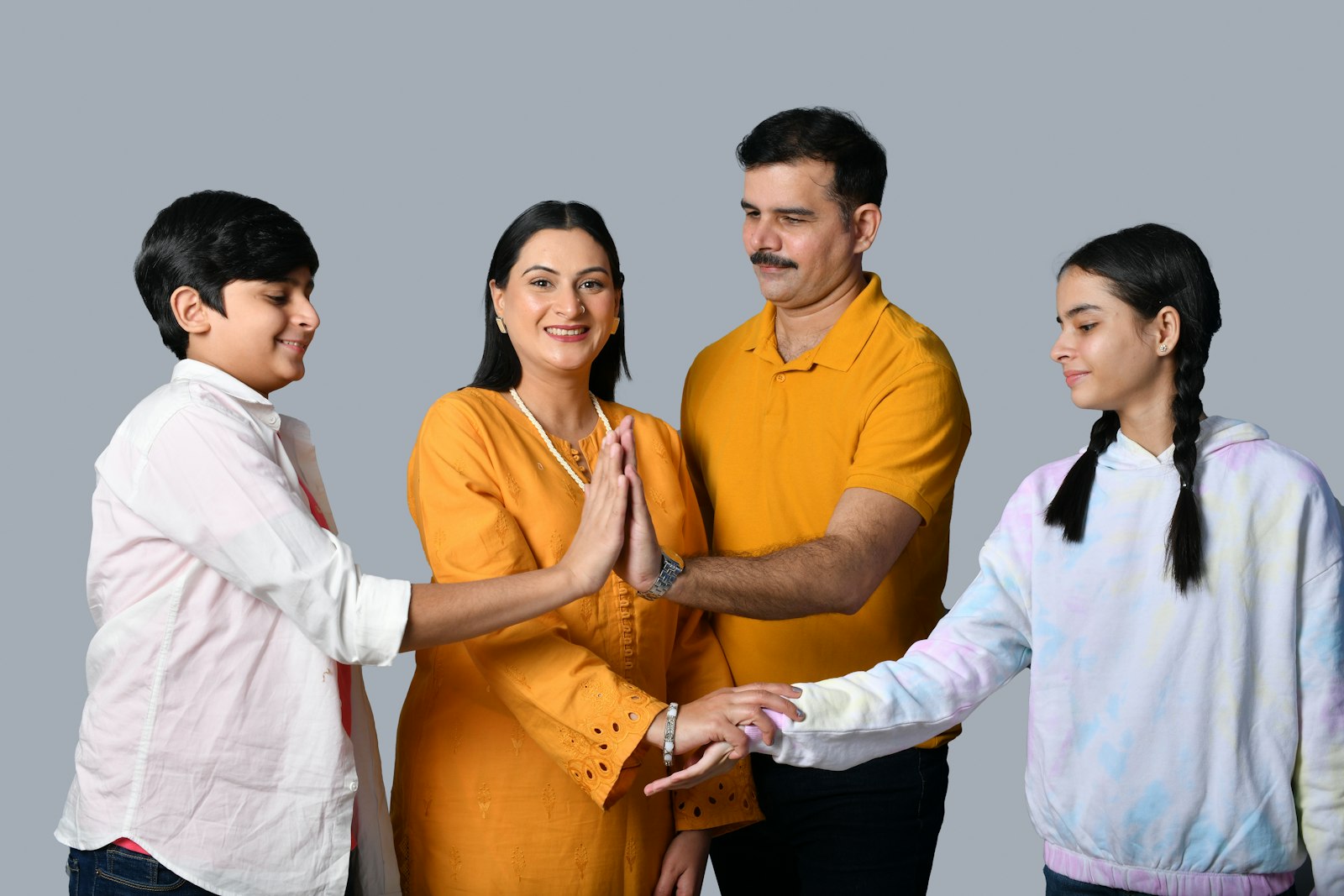 Indian family of four smiling together