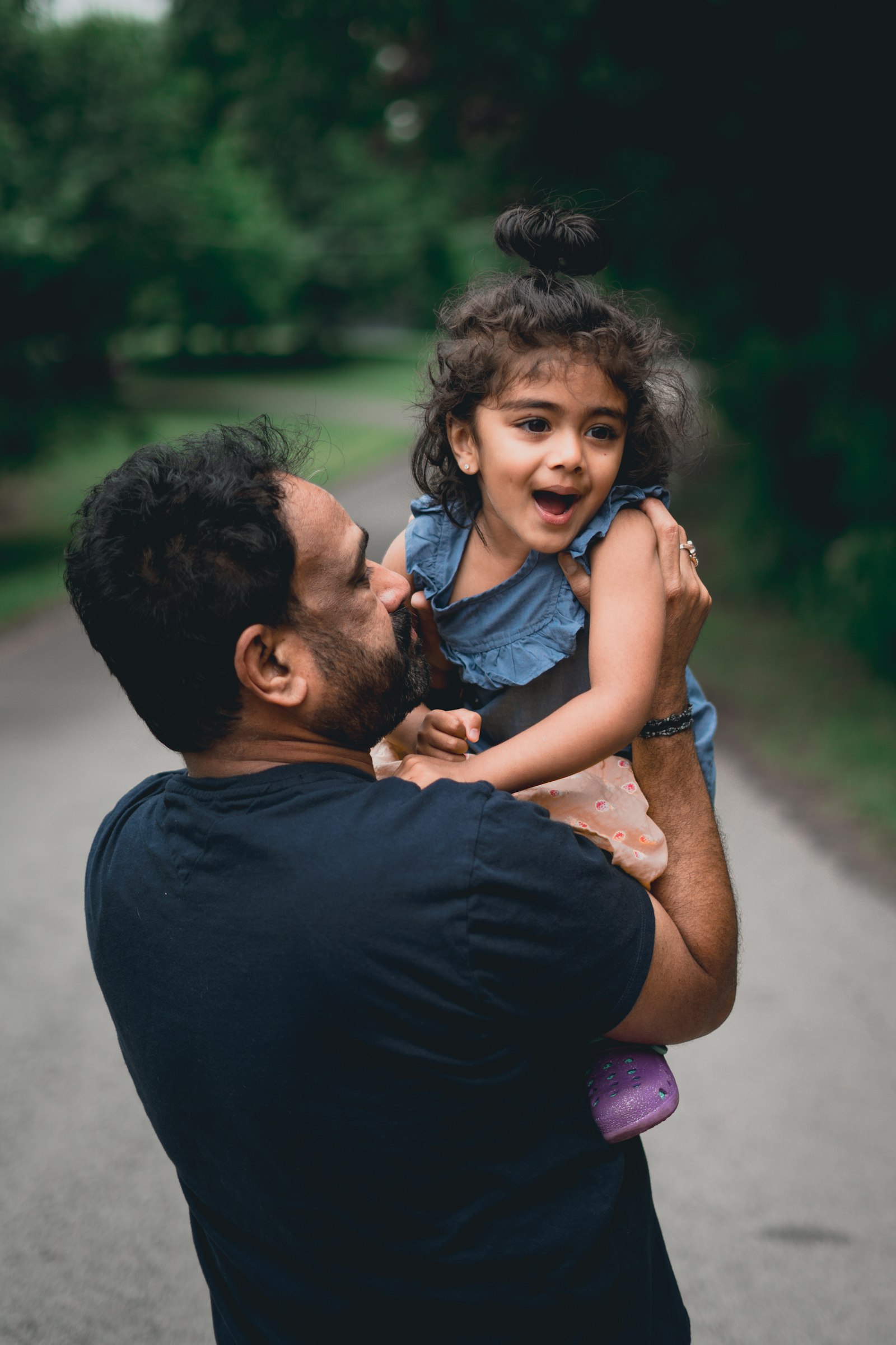 Father lifting his happy young daughter