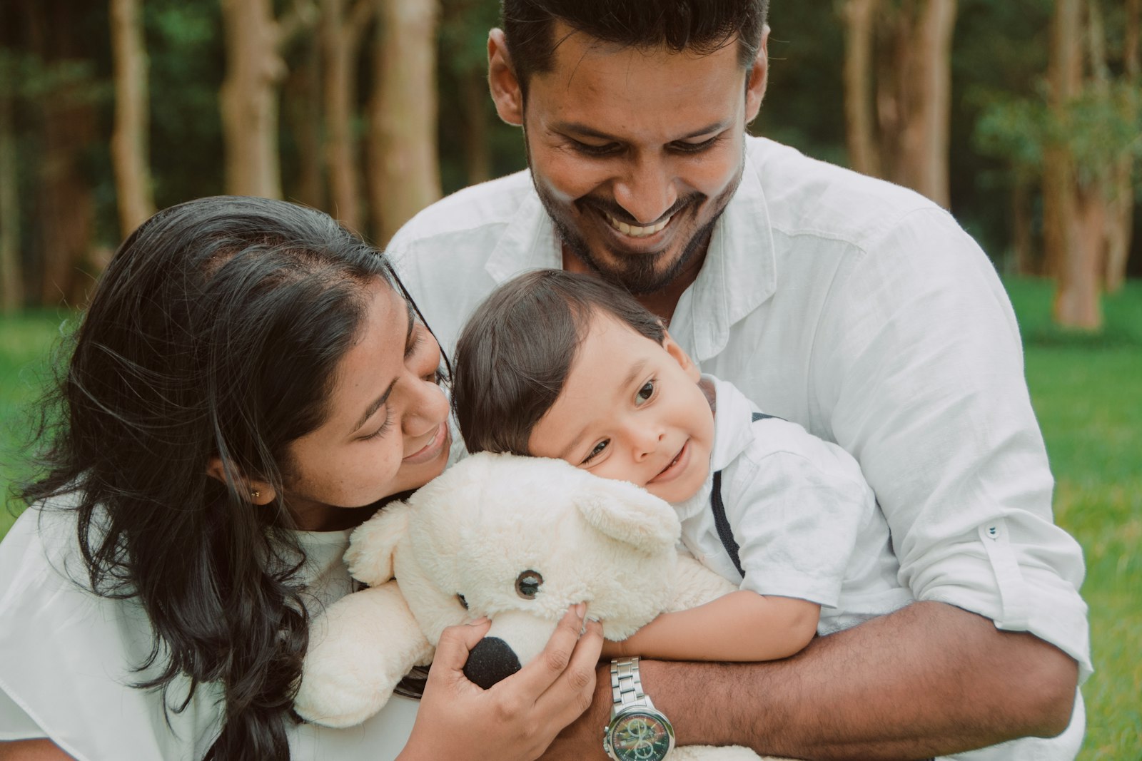 Indian parents smiling with their baby